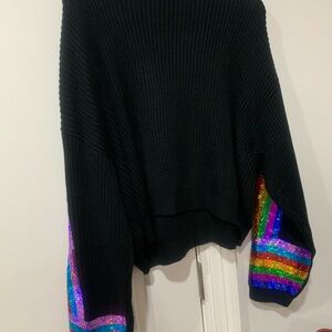 NWOT Queen of Sparkles sequin sweaters. Size “M”. One Black and one White.